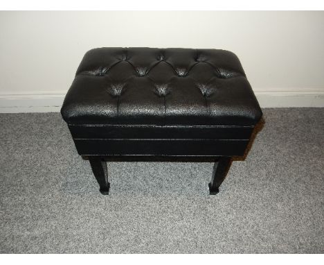 Piano Stool 
A piano stool in a bright ebonised finish with storage under a leather top.
