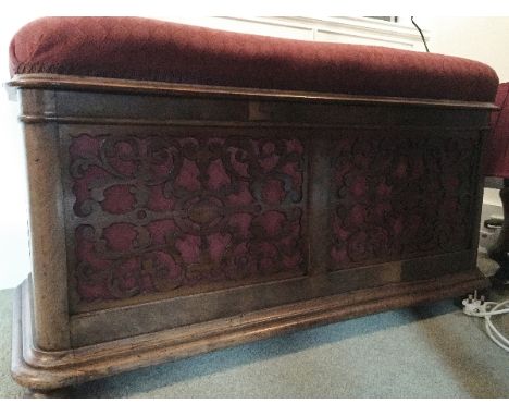 Piano Stool
A figured walnut duet piano stool with fretwork front and sides upholstered in red fabric with compartmented stor