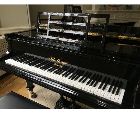 Blüthner
An early 20th century 6ft 3in Style 7 grand piano in a bright ebonised case on turned and fluted legs, together with