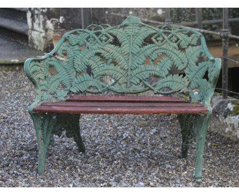 A rare 19th Century English cast iron two-seater Garden Bench, by Coalbrookdale, stamped with initials, the shaped back and l