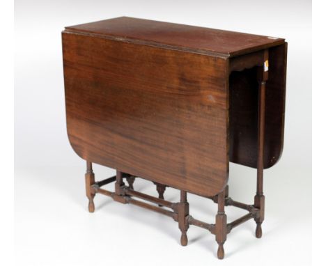 An Edwardian mahogany Yacht Table, the demi lune flaps supported by a gate leg mechanism on spider type legs. (1)