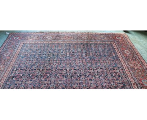 A very fine quality large 19th Century Oriental Carpet, the wide centre with blue ground and intricate design and multiple bo