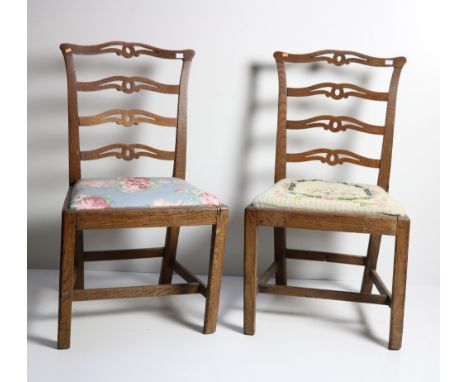 A pair of 19th Century ladder back oak Side Chairs, with carved and pierced backs and with drop in seats on square front legs