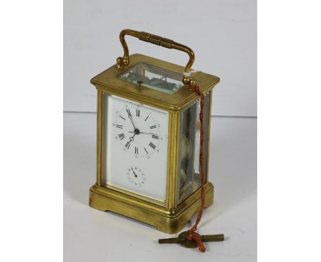A 19th Century brass repeater Carriage Clock, with shaped carrying handle and exposed mechanism with Roman numeral dial, poss