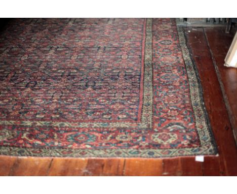 A very good late 19th Century / early 20th Century large Feraghan wool Carpet, the rich red ground decorated with centre of a