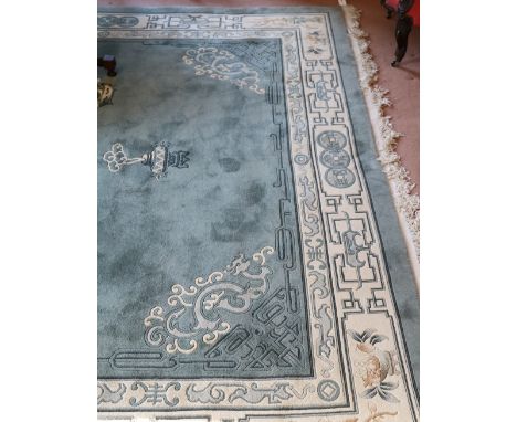 A fine quality heavy woolen blue ground Oriental Carpet, the large central panel with circular Chinese decorations with cream