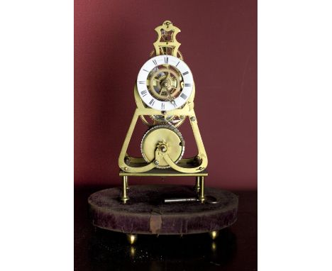 A 19th Century English brass and enamel dial Skeleton Clock, by Davidson London, on associated stand. (1)