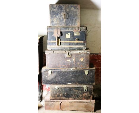 Seven old tin Travel Trunks &amp; Deed Boxes, some with names on brass plaques etc., an old leather Trunk and a pine Table. A