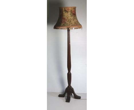 A mahogany Standard Lamp, formed from a fluted Georgian bedpost on four outsplayed legs with floral decorated shade. (1)