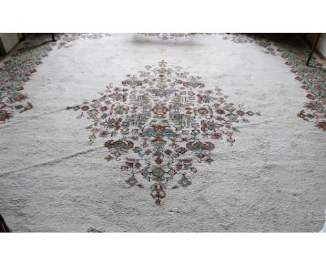 A large and attractive cream ground heavy pile Donegal Carpet, with wide decorative border and three central decoration lozen