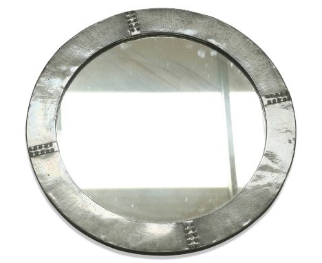 A LIBERTY &amp; CO ARTS AND CRAFTS PEWTER MIRROR, circular, spot-hammered, labelled. 56.5cm diameter