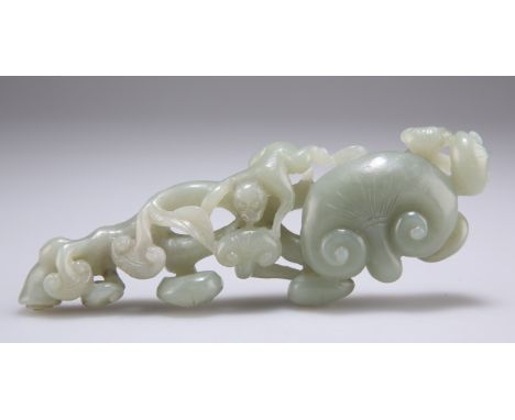 A CHINESE JADE CARVING,&nbsp;of a monkey feeding on lingzhi fungus sprays issuing from an entwining branch, the stone of cela