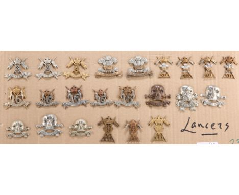 A COLLECTION OF CAP BADGES, COLLAR BADGES AND ARM BADGES, of regiments of Lancers of the British Army, on card.&nbsp;(23)