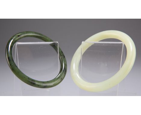 A CHINESE NEPHRITE JADE BANGLE, 7.7cm diameter; together with ANOTHER BANGLE. (2)CONDITION REPORTSecond bangle probably serpe