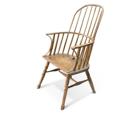 A PRIMITIVE ELM STICK-BACK WINDSOR CHAIR, 19TH CENTURY, Vale of York, raised on turned legs joined by an H-stretcher. Height 