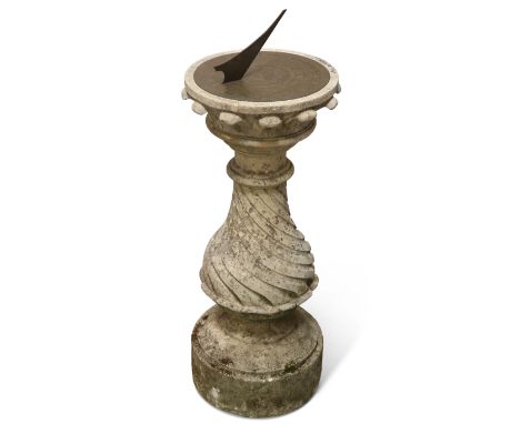 A STONE-MOUNTED BRASS SUNDIAL, the circular brass dial engraved with a bearded mask to centre beneath the gnomon, and 'Make t
