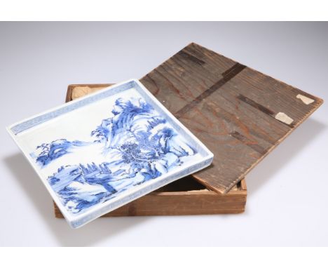 A CHINESE BLUE AND WHITE PORCELAIN DISH, square with raised edge, painted with a mountainous landscape, bears blue seal type 