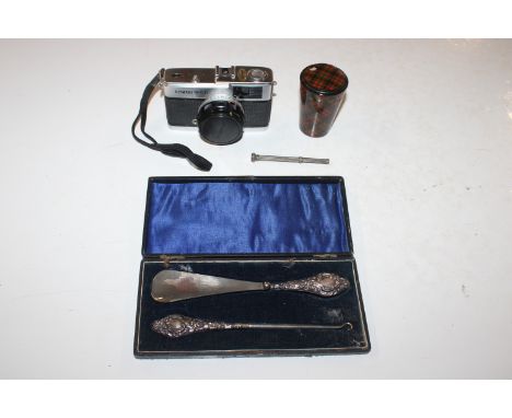 A cased silver handled shoe horn and button hook; a tartan ware box and cover; a propelling pencil; and an Olympus Trip 35 ca