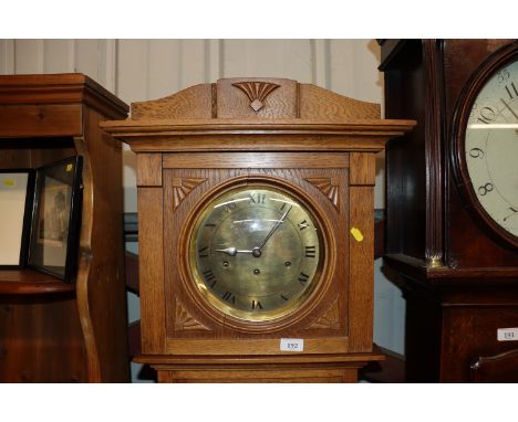 An oak and glass cased chiming grandfather clock 