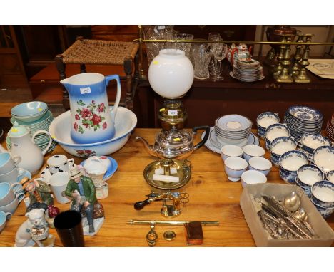 A silver plated tea pot; an oil lamp with milk glass shade and glass chimney; a brass chamber stick; candle snuffers etc.