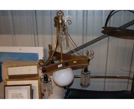 A gilt and bronzed pendant four light chandelier with glass prism drops 