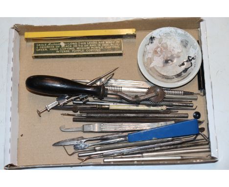 A box of vintage metal tools for artwork and print making 