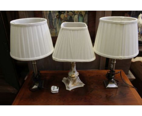An oval gilt white ceramic table light, together with a pair of modernist brush metal effect lights 