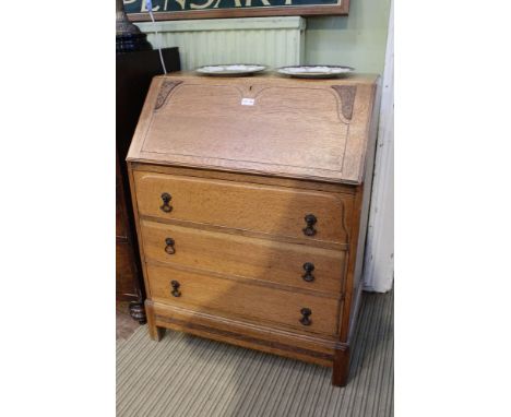 A mid-century light finished bureau, three full width drawers above a freeze on plain blocked legs 