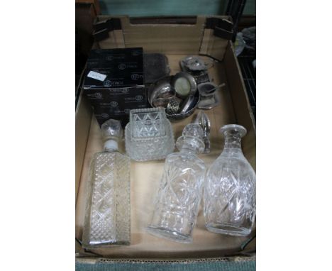 A box containing decanters and stoppers domestic metal wares to include hallmarked silver frames etc. 