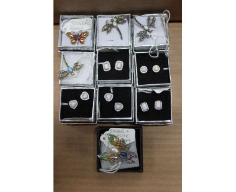 A box containing a selection of silver mounted earrings and small sized bug brooches 