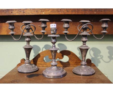 A pair of silverplated three sconce table candelabrum, together with a single table lamp 