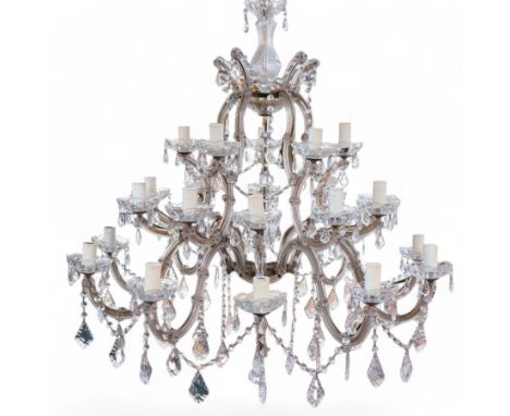 Late 20th century three-tier chandelier, serpentine metal frame supporting twenty-five branches, the frame clad with glass pa