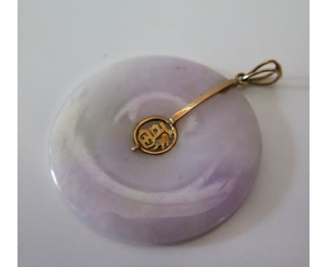 A Chinese Jade Bi Disc with 14K gold mount, c. 4 cm diam.