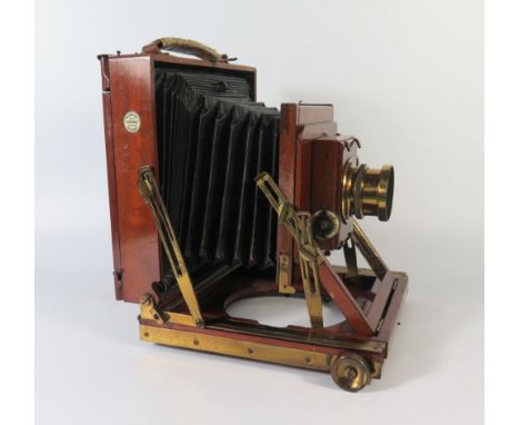 A Thornton Pickard _ Beck Mahogany and Brass Mounted Bellows Camera with symmetrical lense, plates, box and extending tripod