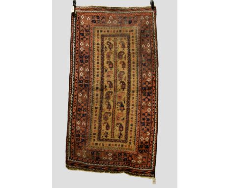 Four Baluchi rugs, Khorasan, north east Persia, late 19th/20th century, the first with camel field, the central tree flanked 