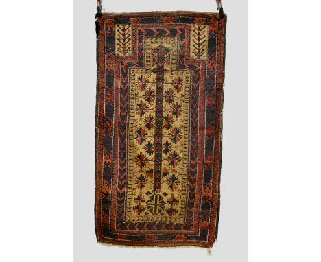 Three Baluchi rugs, Khorasan, north east Persia, late 19th/early 20th century; the first a prayer rug with camel field, 5ft. 