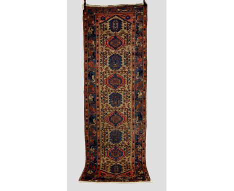 Two runners, the first: Hamadan with camel field, north west Persia, circa 1930s, 10ft. 2in. x 3ft. 6in. 3.10m. x 1.07m. Over