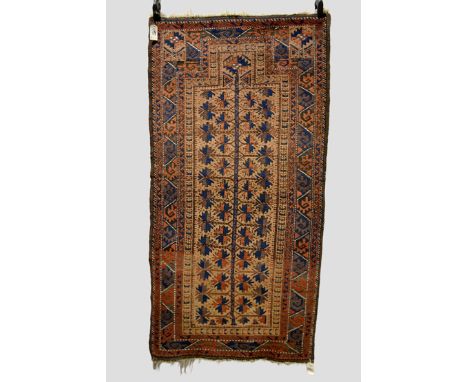 Three Baluchi rugs, Khorasan, north east Persia, late 19th/early 20th century, the first a prayer rug with camel field, 5ft. 