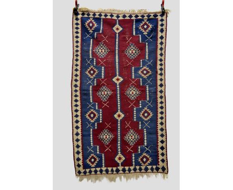 Five Anatolian kelims, all modern, the first with narrow centre pole medallion and ivory border, 5ft. 11in. x 3ft. 6in. 1.80m