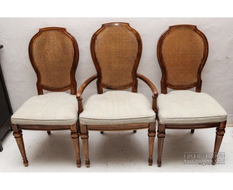 A set of six dining chairs, rattan backs and upholstered seat, on carved tapering legs, including two carvers (6)
Matching di