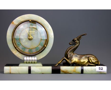 An Art Deco onyx and gilt metal mantle clock, W. 38, H. 22cm. Understood to be in working order.