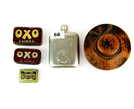 An interesting carved circular wooden box in the shape of a lady's bonnet together with a pewter hip flask and three advertis