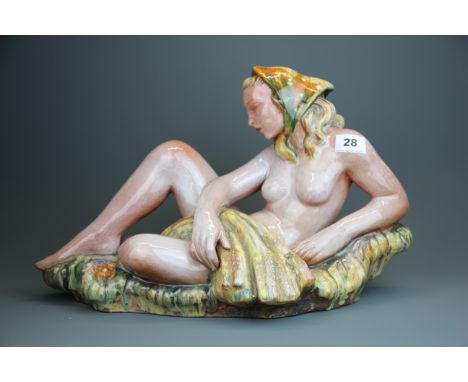 A mid 20th Century Czechoslovakian Goldscheider type glazed pottery figure of a female nude, L. 47cm, H. 27cm.