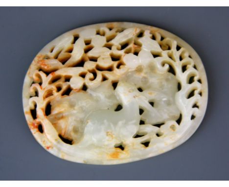 A 19th / early 20th Century Chinese carved mutton fat and russet jade boxed panel featuring a deer among foliage, W. 7.5cm.