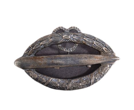 A post WWI First World War Imperial German Army Zeppelin badge. Horizontal oval shape with an airship facing left superimpose