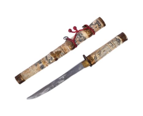 A 20th Century Japanese Tanto knife / dagger with bone scrimshaw handle and scabbard. Extensively carved to depict Japanese l