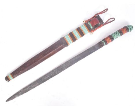 A vintage East African Maasai People tribal seme / machete knife / Tuareg sword. Plaited leather grip, long tapering double s