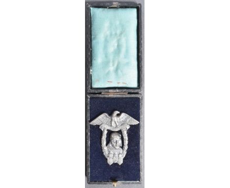 A WWI First World War Austro-Hungarian pilot / flyers badge depicting an aviator's head with within a laurel wreath and an ea