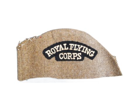 A WWI First World War RFC Royal Flying Corps officers uniform shoulder title. The patch mounted to a section of khaki uniform
