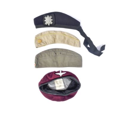 A collection of x4 Military berets comprising a WWII Second World War American female side cap, WWI First World War Black Wat